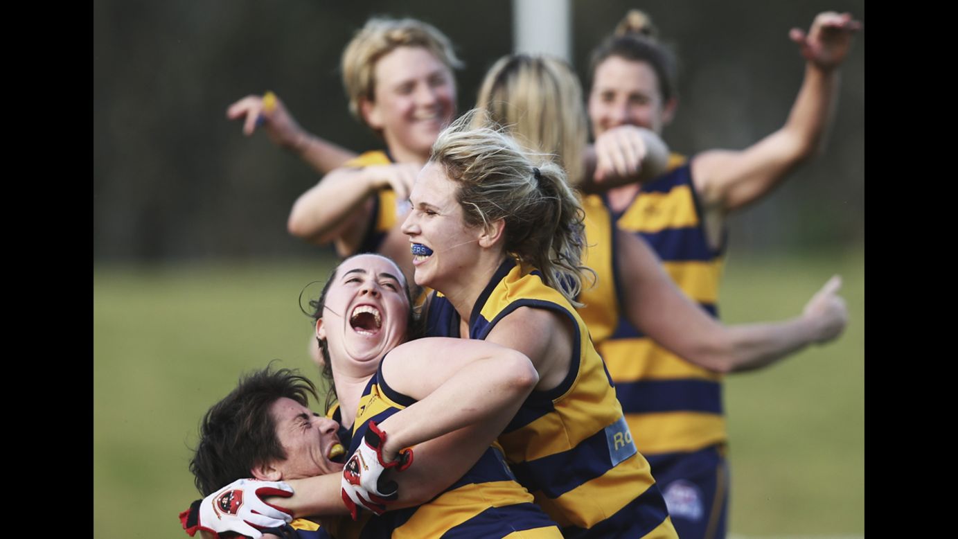 The Sydney University Bombers celebrate Saturday, September 13, after defeating the UNSW-ES Stingrays in the grand final of the Sydney Women's Australian Football League.