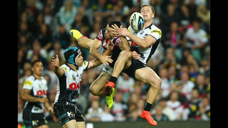 Matt Moylan of the Penrith Panthers, right, collides with Anthony Minichiello of the Sydney Roosters as they compete for a ball during a National Rugby League match in Sydney on Saturday, September 13. Penrith won 19-18 to advance to the league's preliminary finals.