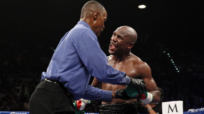 Boxer Floyd Mayweather complains to referee Kenny Bayless, saying that Marcos Maidana bit his fingers during their welterweight title fight Saturday, September 13, in Las Vegas. Mayweather, the WBA and WBC champion, would go on to win the fight by unanimous decision. Maidana denied biting Mayweather.
