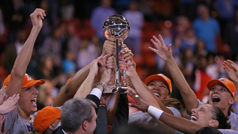 Members of the Phoenix Mercury hold the championship trophy after defeating the Chicago Sky in the WNBA Finals on Friday, September 12. It is the third WNBA title for Phoenix, which also won the league in 2007 and 2009.