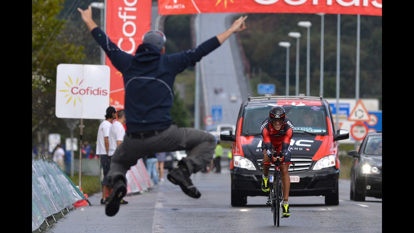 A cycling fan leaps in front of Philippe Gilbert during the final stage of the Tour of Spain on Sunday, September 14. Alberto Contador won the overall race.