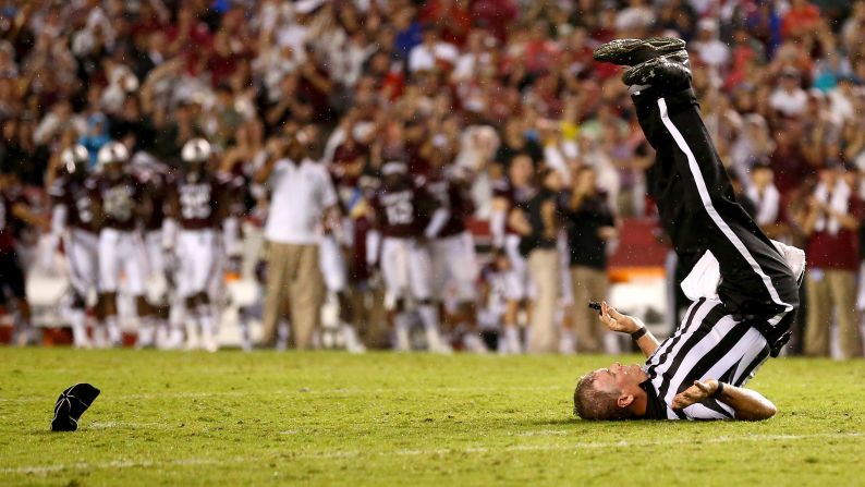 Russ Pulley, a college football official, falls down on a play during the Georgia-South Carolina game Saturday, September 13, in Columbia, South Carolina.