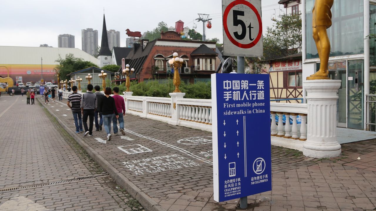 A Chinese city has divided a sidewalk on one of its busiest streets into two lanes -- one for cellphone users and the other for those without. Chongqing painted the lines on busy sidewalk to avoid "potential safety hazards."