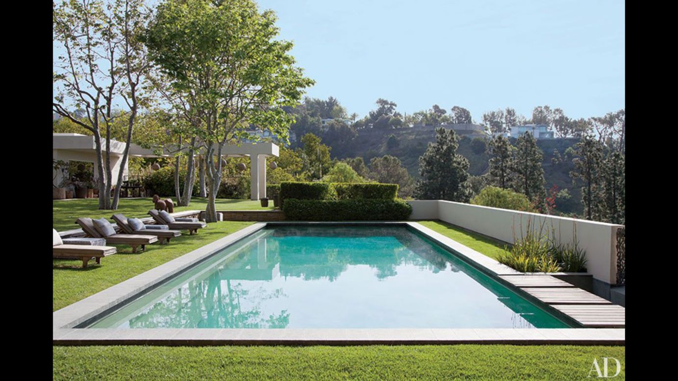 Brazilian granite borders the pool at the Beverly Hills estate of Ellen DeGeneres and Portia de Rossi.