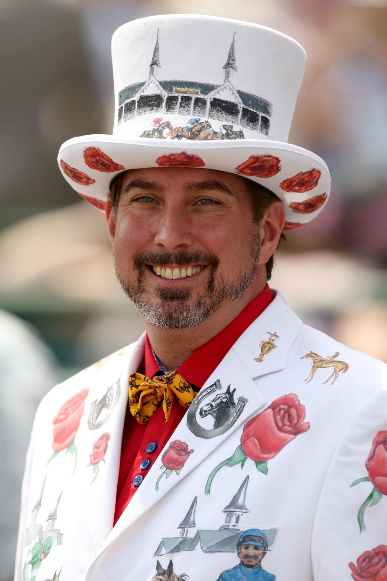 A race fan wearing a festive hat and suit attends the 140th running of the Kentucky Derby at Churchill Downs on May 3, 2014 in Louisville, Kentucky. 