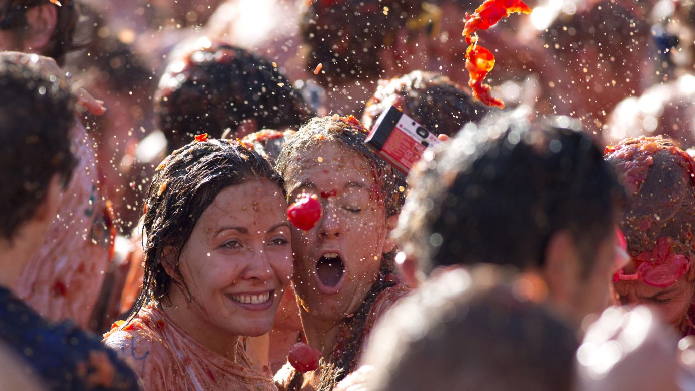 A tomato is about to hit two women as they take a selfie during a tomato fight in front of the Royal Palace in Amsterdam, Netherlands, on Sunday, September 14. The event was marketed as a protest of Russia's boycott of European produce.