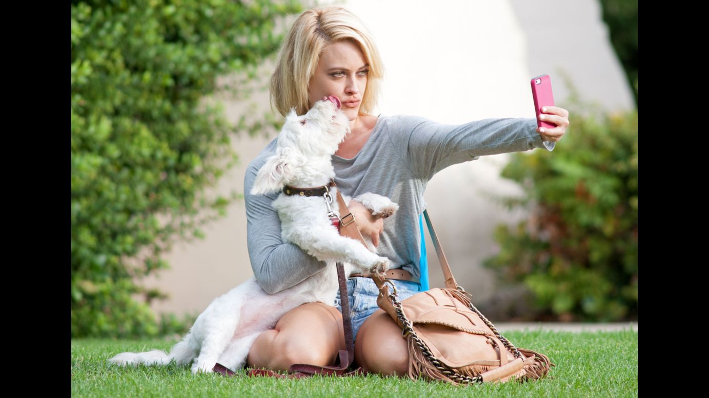 Professional dancer Peta Murgatroyd snaps a selfie with a playful puppy in Los Angeles before heading to rehearsal for the television show "Dancing with the Stars" on Wednesday, September 10.