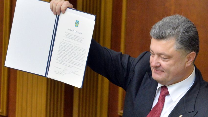 Ukrainian President Petro Poroshenko shows a newly voted Ukrainian law about the ratification of the Ukraine-EU association agreement on September 16, 2014 at the Ukrainian Parliament in Kiev. The Ukrainian and European parliaments on September 16 simultaneously ratified a landmark pact at the heart of the ex-Soviet country's bloodiest crisis since independence. AFP PHOTO/GENYA SAVILOVGENYA SAVILOV/AFP/Getty Images