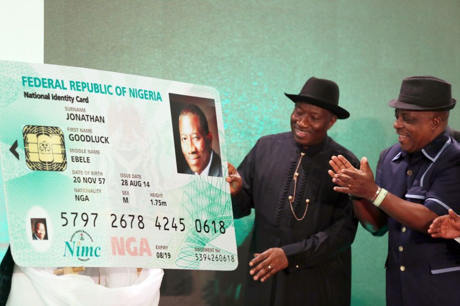 Nigerian President Goodluck Jonathan looks at the replica of his electronic identity card during the launching of the cards in Abuja on August 28.