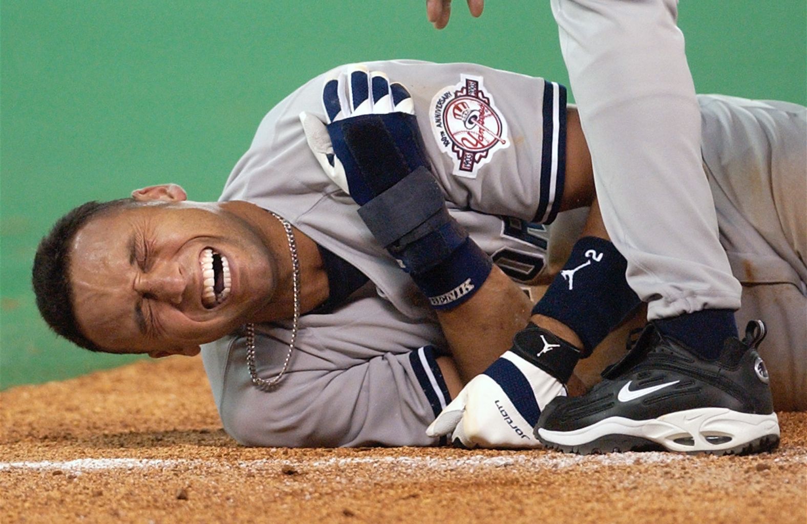 Jeter grimaces after a third-base collision in Toronto in March 2003. Jeter hurt his shoulder and went on the disabled list. It was one of the few times in Jeter's 20-year career that he missed significant time because of injury.