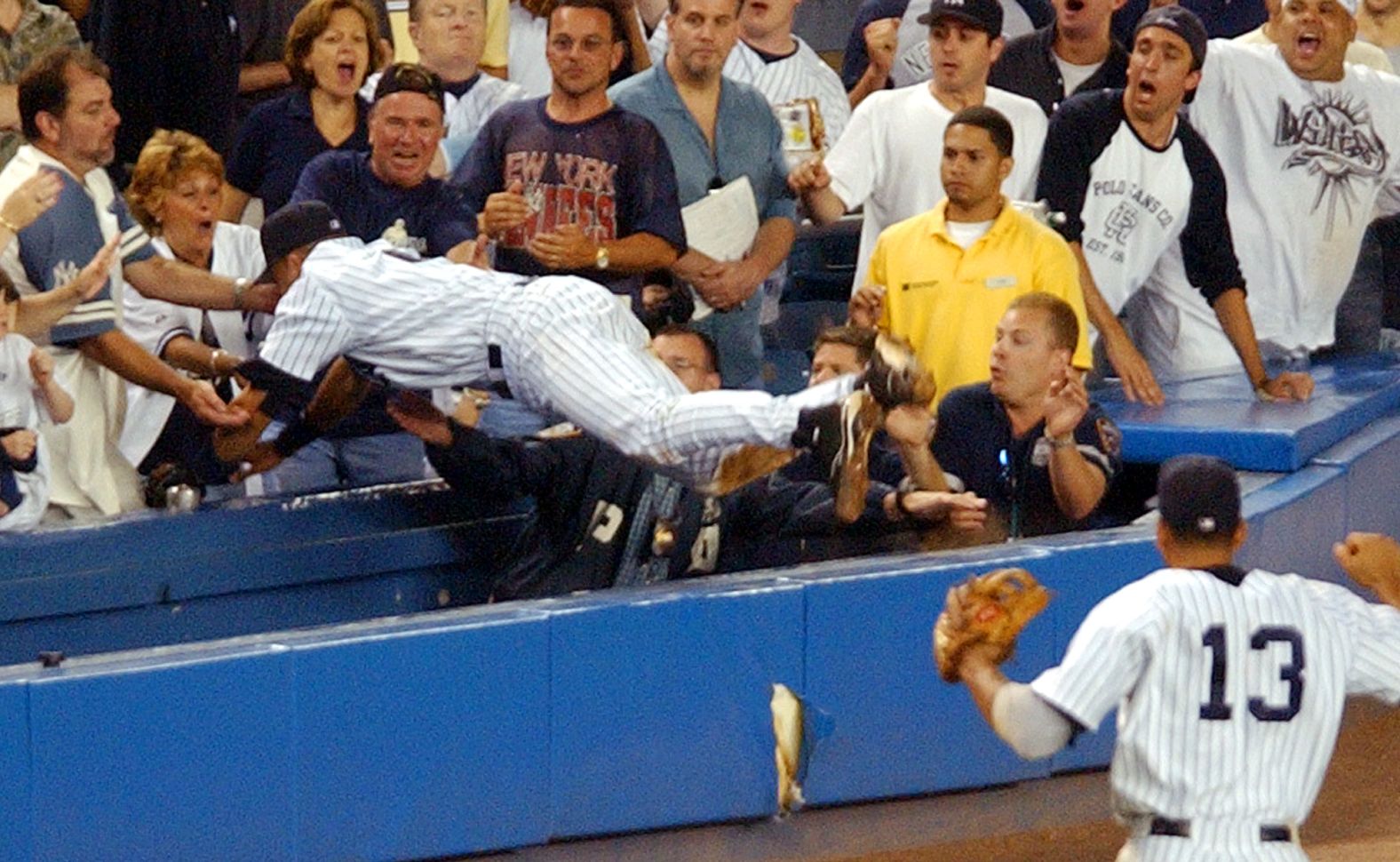 Jeter dives into the stands at Yankee Stadium to catch a foul ball in July 2004.