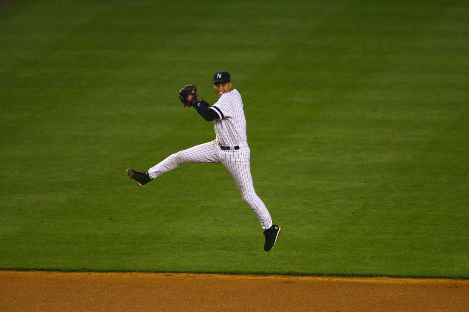 Jeter jumps into the air before throwing the ball to first base in May 2007.