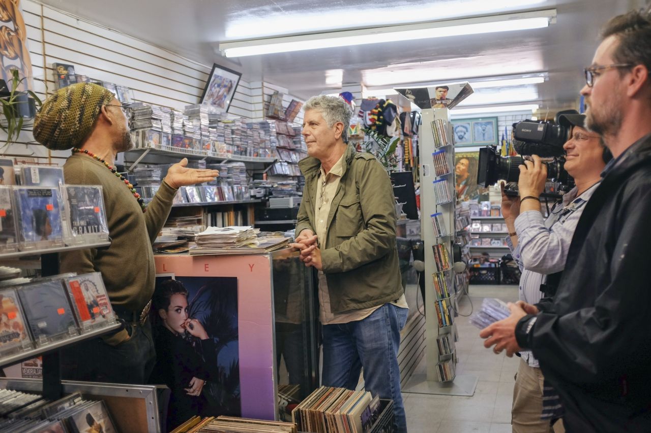 Bourdain talks with DJ Kool Herc at Moodies Records.