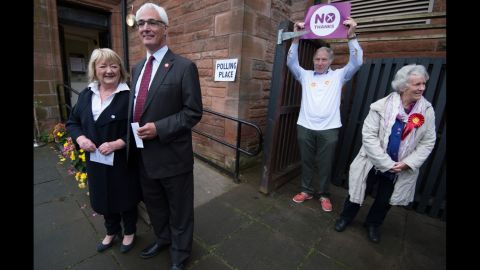 Darling, second from left, stands with his wife, Maggie, outside a polling station in Edinburgh on September 18.
