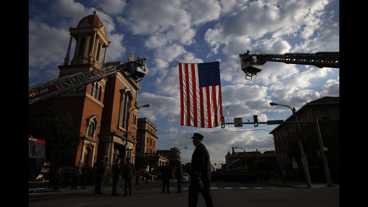 A law enforcement officer arrives for the funeral service.