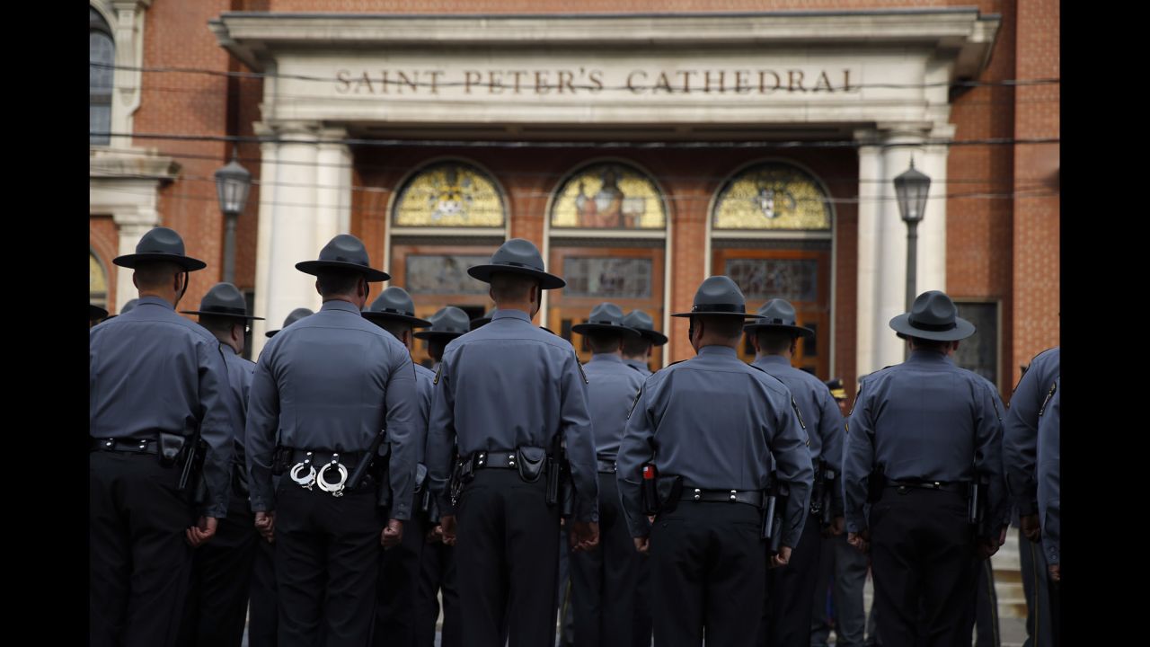 Law enforcement officers gather before the funeral service.