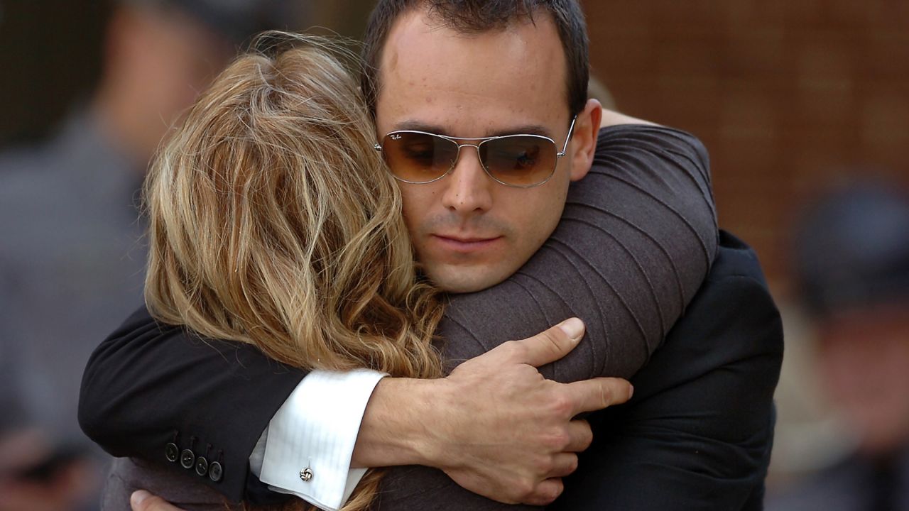 A man and woman embrace outside the viewing.