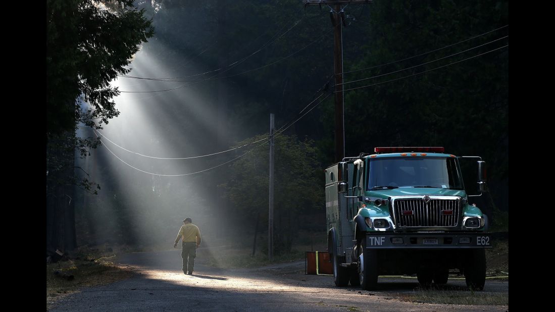 A firefighter walks through smoke in Fresh Pond on Wednesday, September 17.