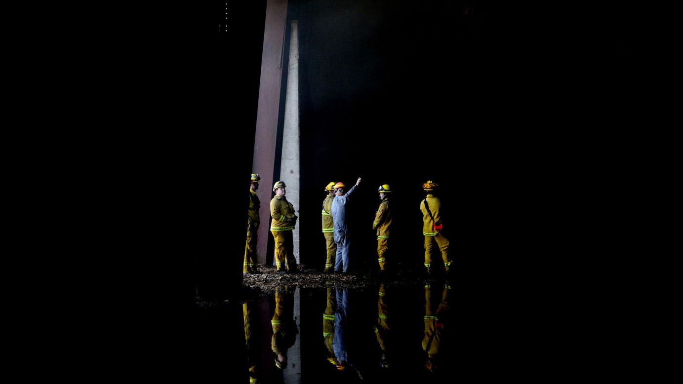 Firefighters inspect the interior of the Roseburg lumber mill in Weed on September 16.