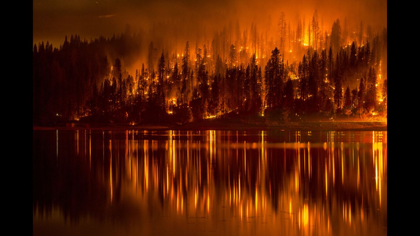 A wildfire approaches the shore of California's Bass Lake on Sunday, September 14.