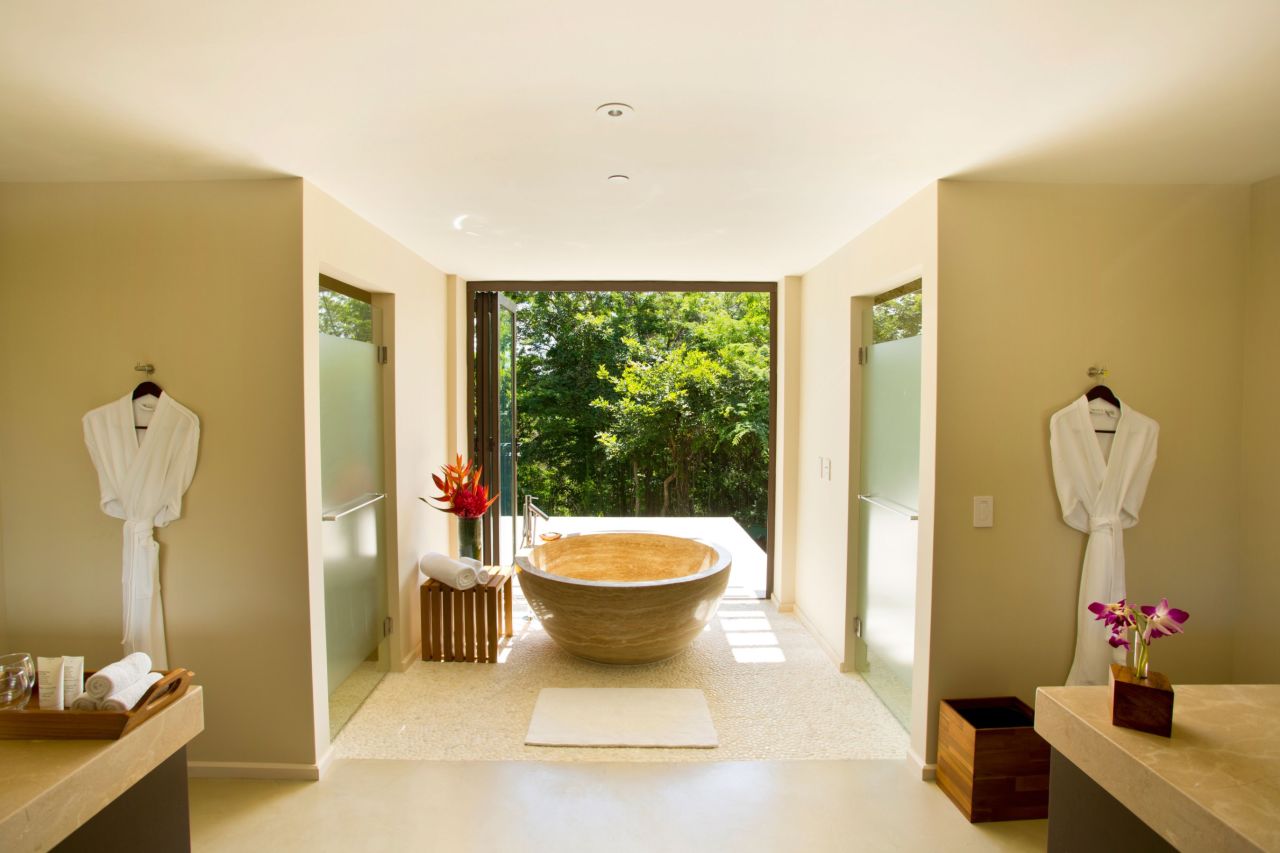 This bathroom at the Andaz Peninsula Papagayo Resort in Costa Rica features a spacious walk-in shower that opens to the balcony.