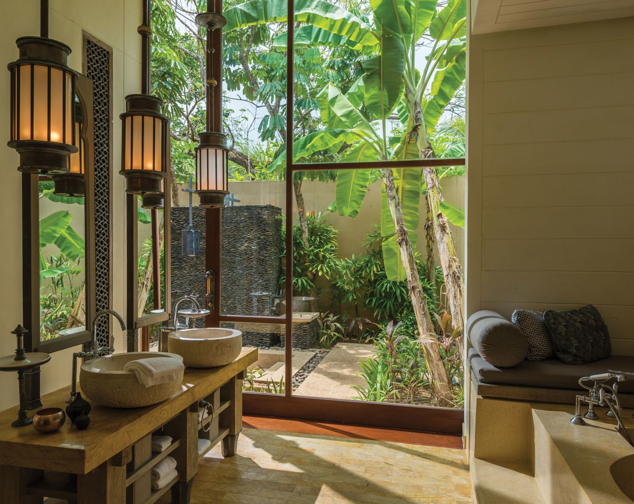 The guest bathrooms of the Four Seasons Resort Langkawi in Malaysia feature soaring arches, bright skylights and outdoor soaking tubs in private gardens.