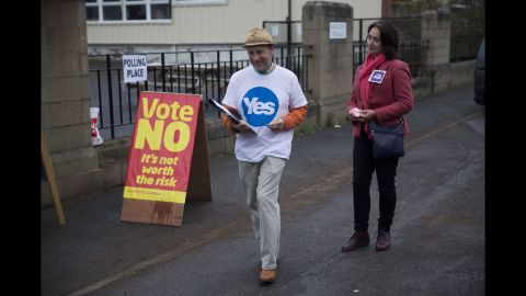 Campaigners stand outside a polling station in Edinburgh on September 18.