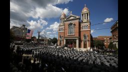 An honor guard carries the casket of Pennsylvania State Trooper Cpl. Bryon Dickson from his funeral service in Scranton, Pennsylvania, on Thursday, September 18.