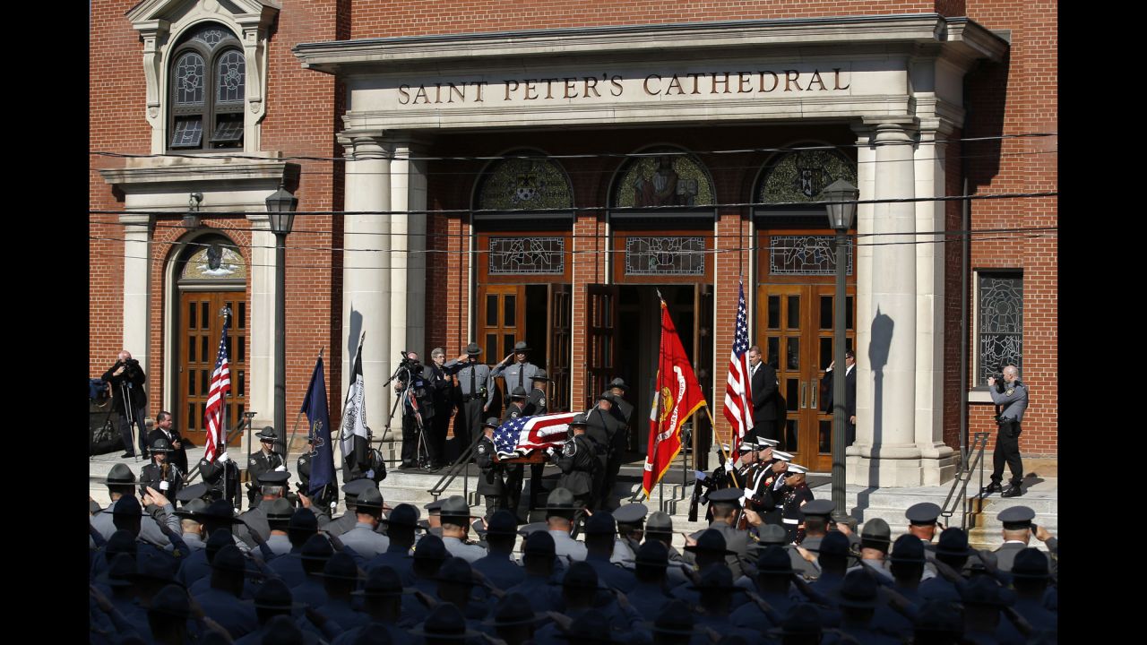 An honor guard carries Dickson's casket before the funeral service.