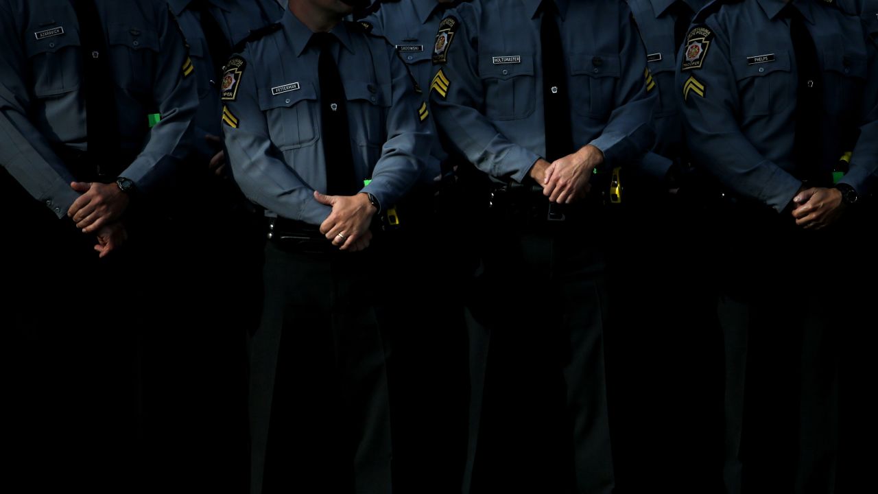 Law enforcement officers gather before the funeral service.