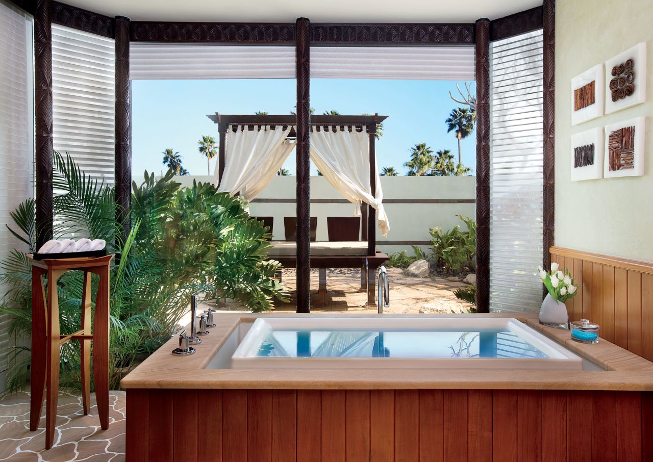 A walk-in power shower and overflow infinity-style Jacuzzi overlooking a sun-soaked garden are just a few of the features at the Ritz-Carlton, Bahrain Hotel & Spa.