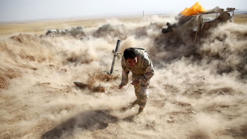 A Kurdish Peshmerga fighter launches mortar shells toward ISIS militants in Zumar, Iraq, on Monday, September 15. ISIS <a href="http://www.cnn.com/2014/06/13/world/gallery/iraq-under-siege/index.html">has taken over large swaths of northern and western Iraq</a> as it seeks to create an Islamic caliphate that stretches from Syria to Iraq.