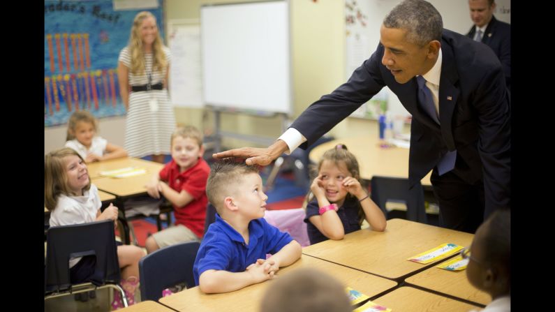 U.S. President Barack Obama touches the hair of Blake Diego while visiting a first-grade class Wednesday, September 17, at MacDill Air Force Base in Florida. The children also got a chance to touch Obama's hair.