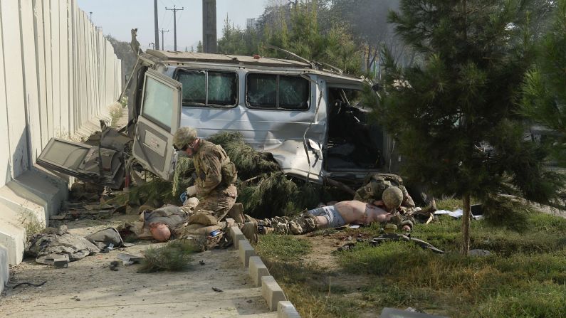 Foreign troops give first aid to victims at the site of a <a href="http://www.cnn.com/2014/09/16/world/asia/afghanistan-violence/index.html">suicide car bombing</a> in Kabul, Afghanistan, on Tuesday, September 16. Three members of NATO's International Security Assistance Force were killed in the attack, the coalition said. At least 13 Afghan civilians were also wounded.
