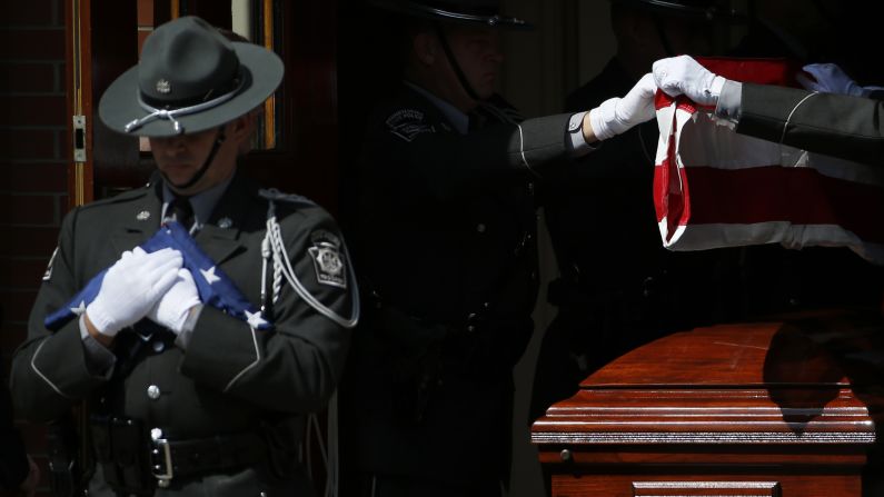 An honor guard folds a flag near the casket of Bryon K. Dickson during <a href="http://www.cnn.com/2014/09/18/us/gallery/pennsylvania-trooper-mourned/index.html">Dickson's funeral service</a> Thursday, September 18, in Scranton, Pennsylvania. Dickson was one of two Pennsylvania state troopers shot last week while they were leaving their police barracks. The other trooper, Alex T. Douglass, was severely wounded.