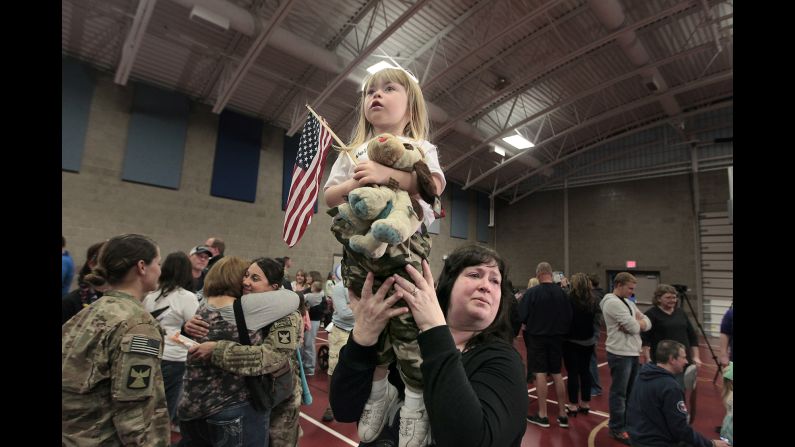 Robin Anderson holds up her granddaughter, Kinlee, while Kinlee searches for her father Tuesday, September 16, in Inver Grove Heights, Minnesota. More than 140 soldiers from the Minnesota National Guard were returning home after a nine-month deployment to Afghanistan.