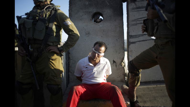 Israeli soldiers detain a Palestinian man Friday, September 12, during clashes at a protest against the Jewish settlement of Ofra, in the West Bank village of Silwad.