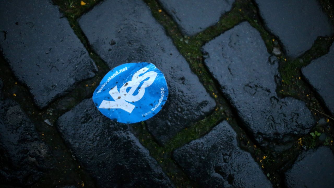 A discarded "Yes" sticker lies on cobblestones along Edinburgh's Royal Mile on September 19.