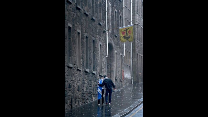 Dejected independence supporters make their way home in Edinburgh on September 19.