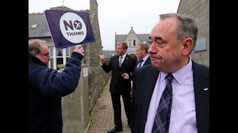 Scottish First Minister Alex Salmond passes an pro-union campaigner in Ellon, Scotland, on September 18. Salmond, leader of the independence movement, later accepted defeat and urged supporters to do the same.