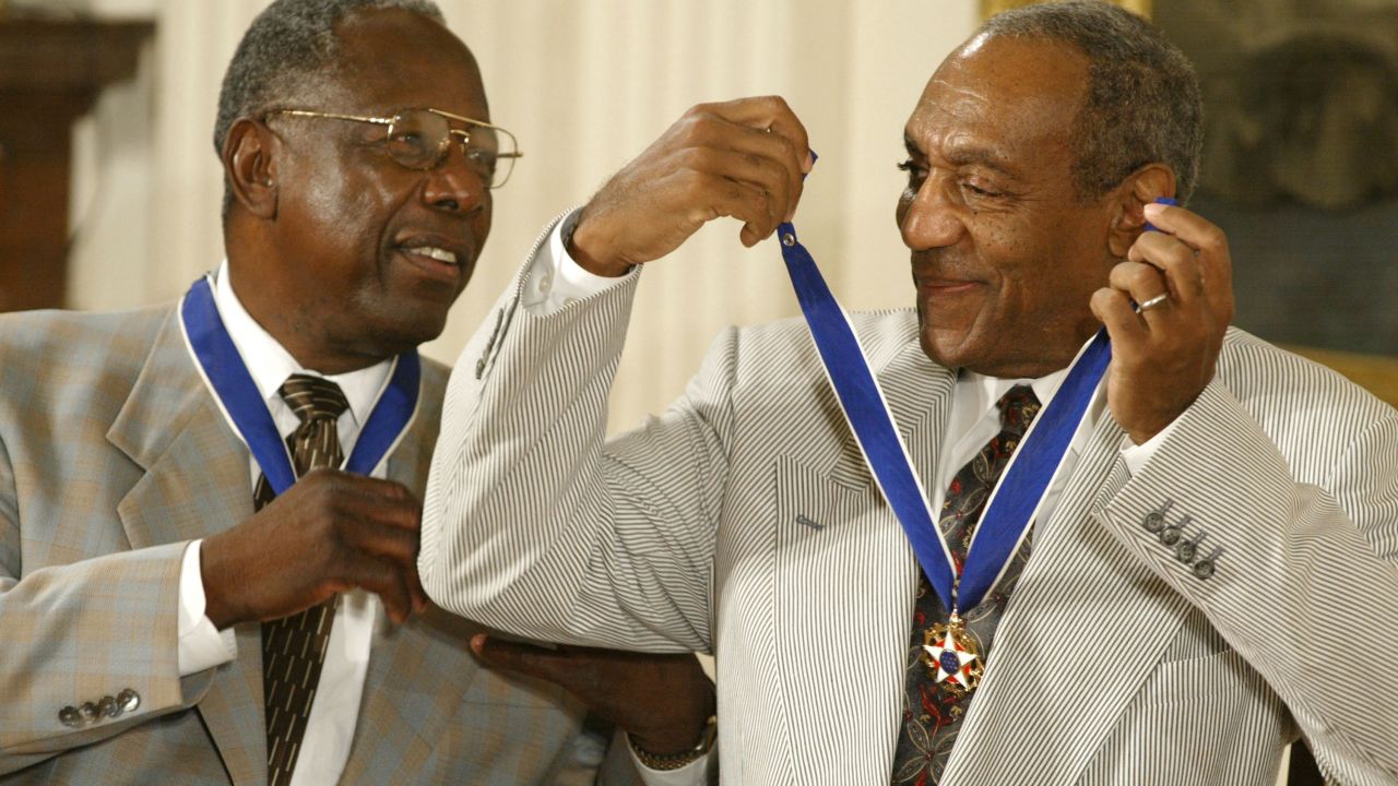 Cosby shares a laugh with baseball great Hank Aaron after they both received the Presidential Medal of Freedom in 2002. The medal is America's highest civilian award.