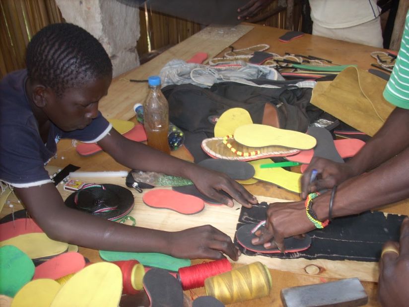 The youngsters work together to design and make the shoes at the Uganda-based center. 