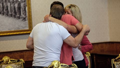 Relatives of Witheridge hug before a police briefing in Bangkok on September 18.