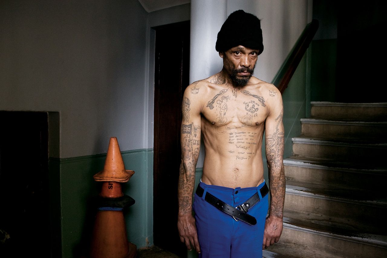 The impulse to identify with a tribe can also be seen in criminal contexts. A former high-ranking gang member in Cape Town, South Africa, shows off his gangland tattoos. When this picture was taken, in 2007, he had retired and was working as a cleaner and handyman at St. George's Cathedral in Cape Town.