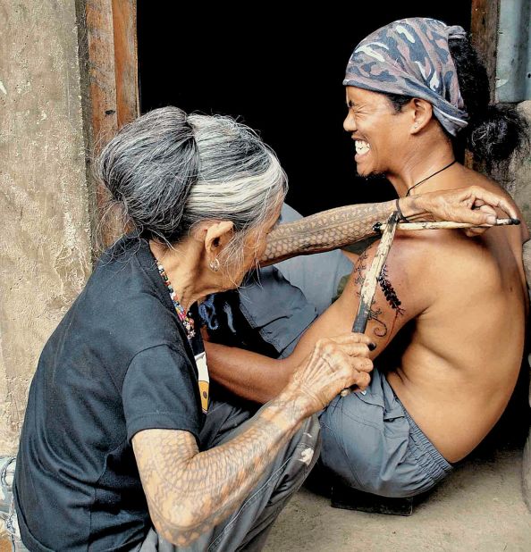 Whang-ud, who was 92 years old when this picture was taken in 2012, has been described as the last traditional tattooist in the Philippines. In recent years, enthusiasts and tourists have hiked for hours to reach the remote village in which she practices.