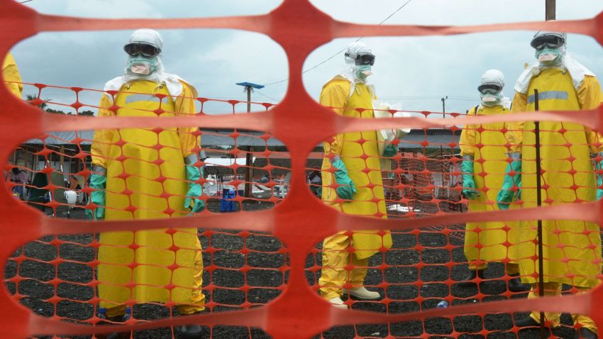 Workers wearing personal protective equipment stand inside the contaminated area at the ELWA Hospital in Monrovia, Liberia. The hospital is run by Médecins Sans Frontières, also known as Doctors without Borders.