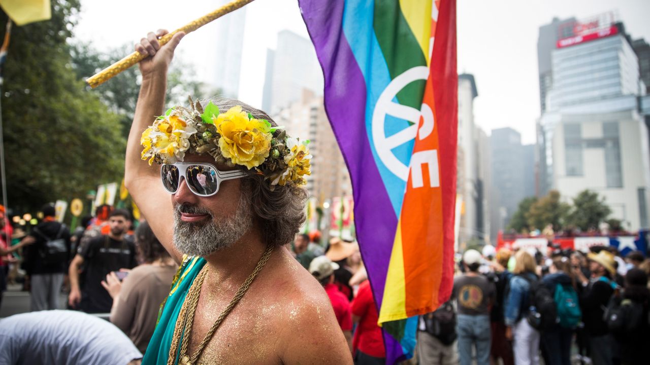A man waves a rainbow flag as he marches in New York.
