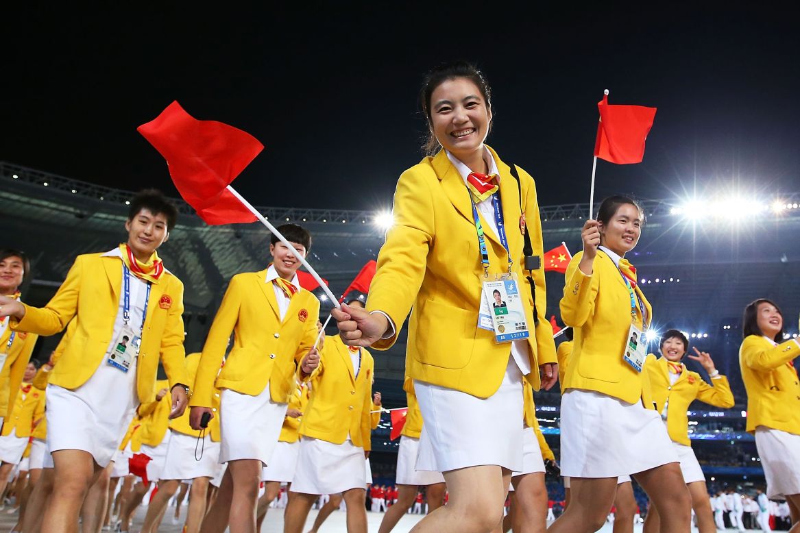 The Chinese team has led the gold medal count at every Asian Games since 1982. They're seen here waving flags as they enter the stadium on September 19.