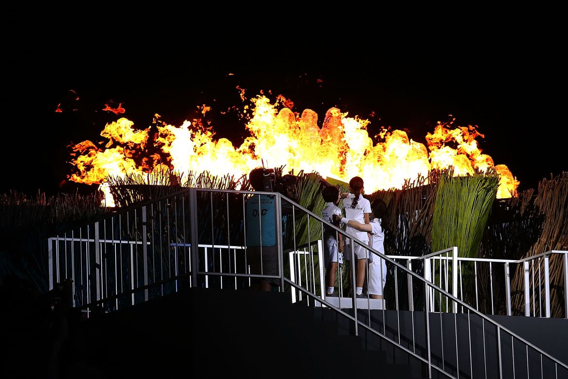 Actress Lee Young-Ae and children Kim Young-Ho and Kim Joowon light the cauldron on September 19. It will burn the competition which ends on October 4.