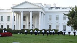 Uniformed Secret Service officers walk along the lawn on the North side of the White House in Washington, Saturday, Sept. 20, 2014. The Secret Service is coming under intense scrutiny after a man who hopped the White House fence made it all the way through the front door before being apprehended.